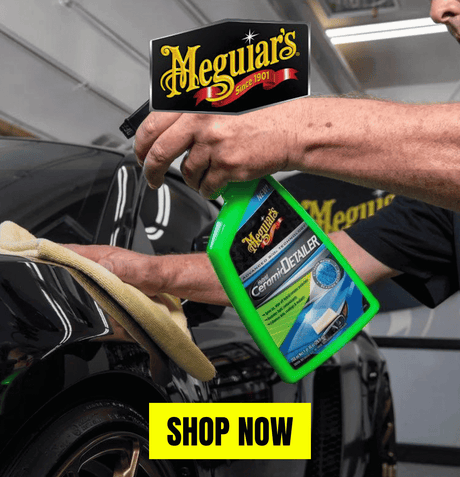 Person applying Meguiar's Hybrid Ceramic Detailer to a car's surface with a yellow microfiber cloth, featuring the Meguiar's logo and a 'Shop Now' button in yellow.